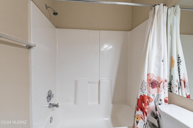 bathroom with shower / bath combination with curtain and toilet