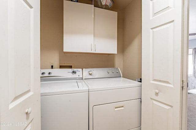 laundry area featuring cabinets and washer and dryer