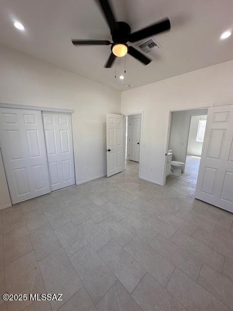 unfurnished bedroom with ceiling fan and a closet