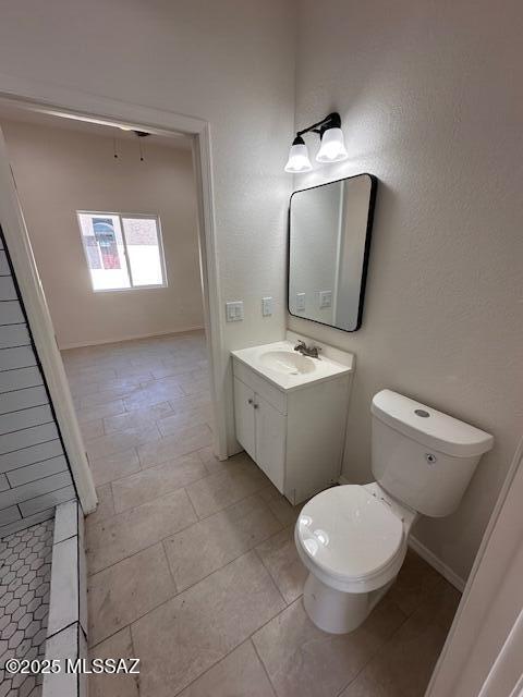 bathroom featuring toilet, vanity, and walk in shower