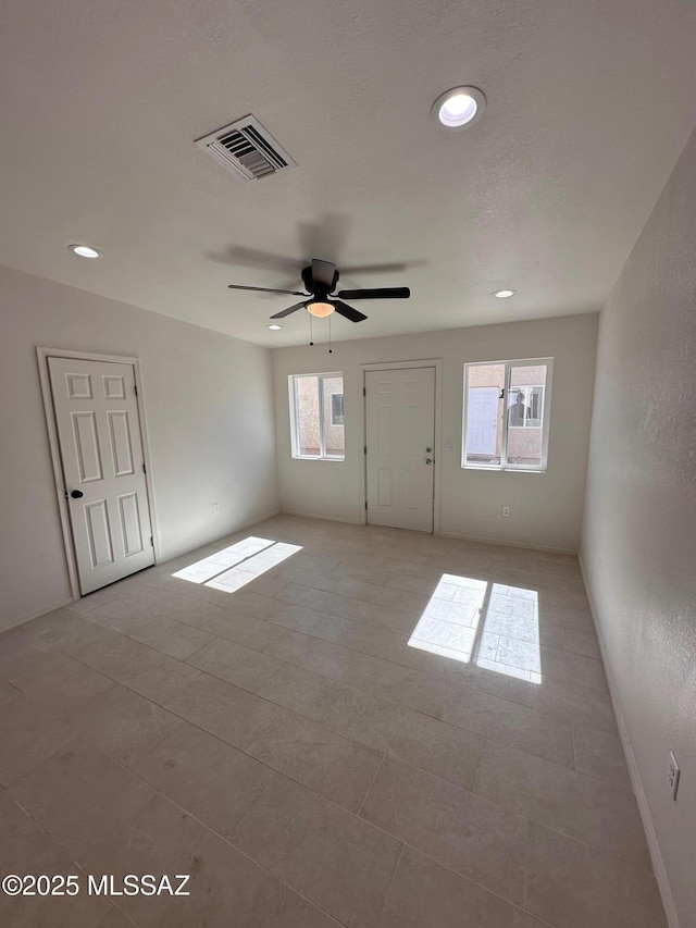 tiled empty room with ceiling fan