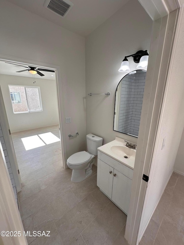 bathroom with ceiling fan, vanity, and toilet