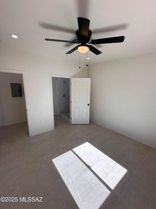 unfurnished bedroom with dark tile patterned flooring, a closet, ceiling fan, and electric panel