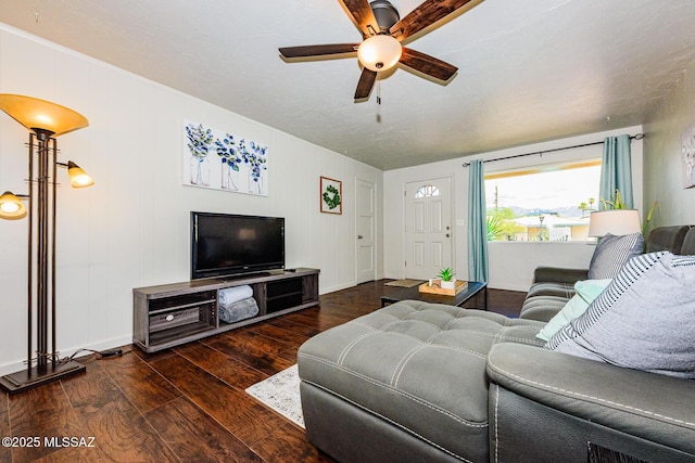 living room featuring ceiling fan and dark hardwood / wood-style flooring