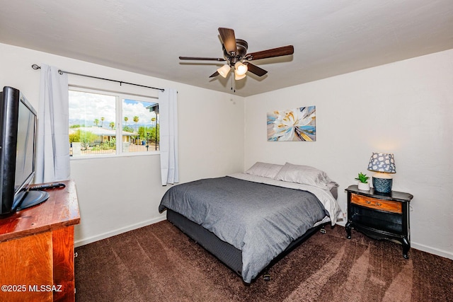 bedroom featuring dark colored carpet and ceiling fan