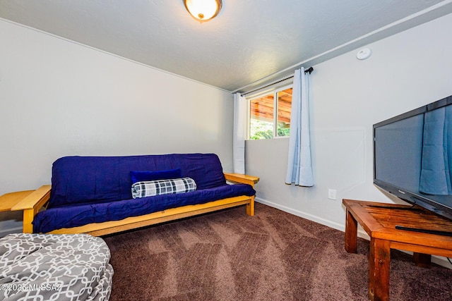 sitting room featuring dark colored carpet and lofted ceiling