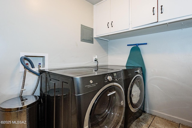 washroom with electric panel, cabinets, light tile patterned floors, and washing machine and dryer