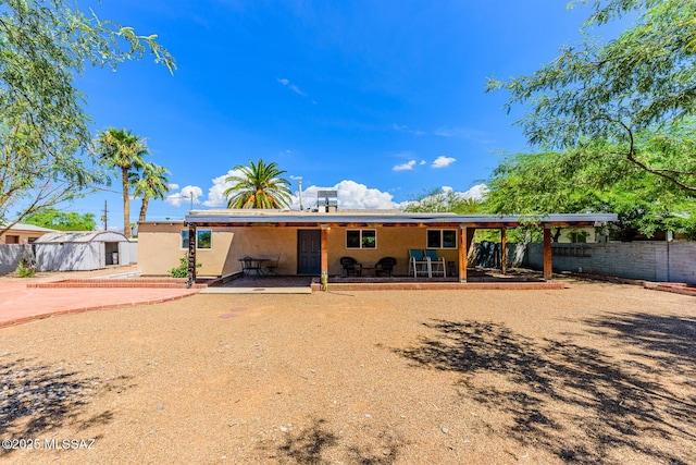 back of property with a patio