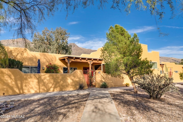 pueblo-style house featuring a mountain view