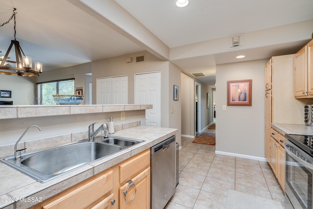 kitchen featuring appliances with stainless steel finishes, decorative light fixtures, sink, a chandelier, and light brown cabinets