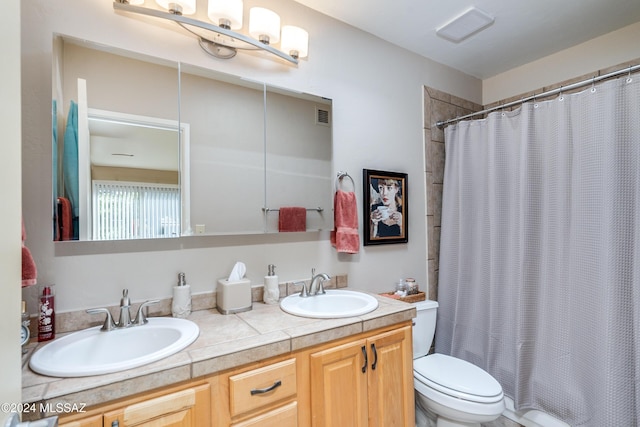 bathroom featuring vanity, walk in shower, and toilet