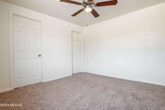 unfurnished bedroom featuring ceiling fan and carpet