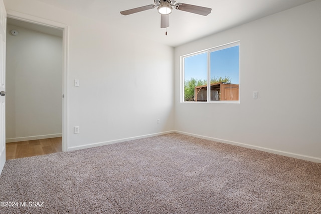 unfurnished room featuring ceiling fan and carpet floors