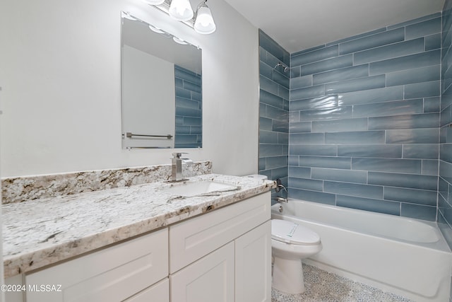 full bathroom with vanity, toilet, and tiled shower / bath