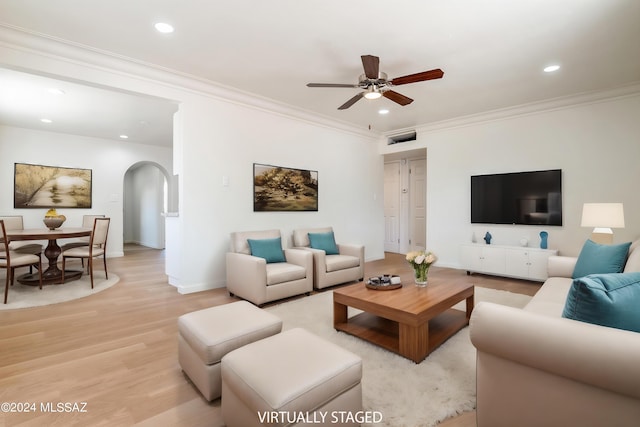 living room with ceiling fan, light wood-type flooring, and crown molding