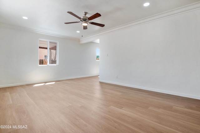 empty room featuring ceiling fan, crown molding, and light hardwood / wood-style flooring