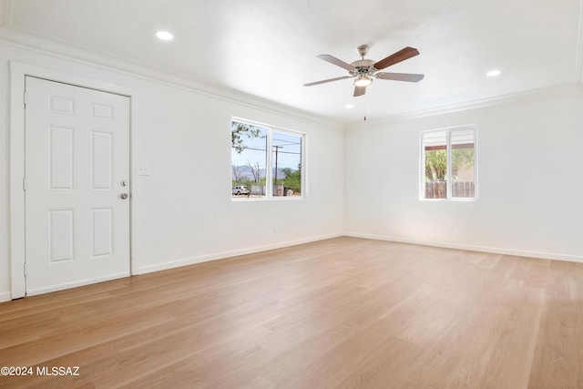 unfurnished room with light wood-type flooring, ceiling fan, and crown molding