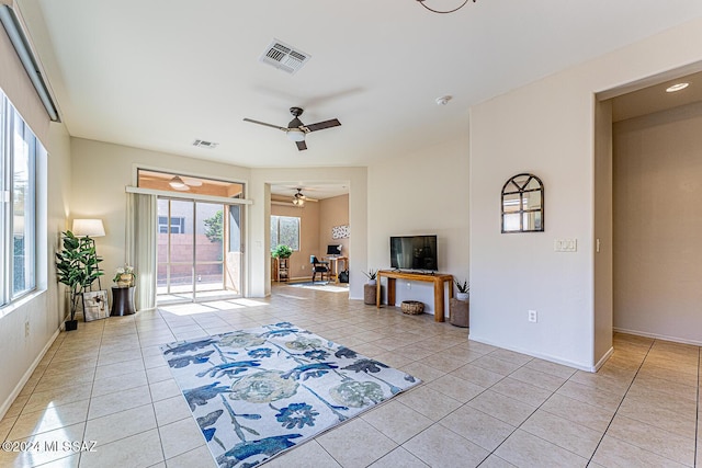 interior space with ceiling fan and light tile patterned floors