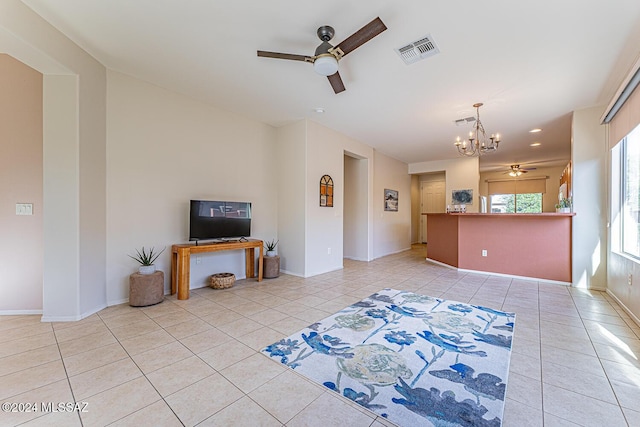 living room with light tile patterned floors and ceiling fan with notable chandelier