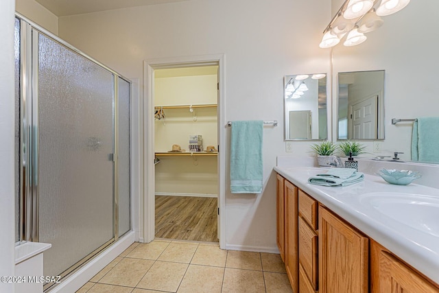 bathroom featuring tile patterned floors, vanity, and walk in shower