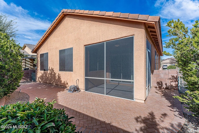 rear view of property featuring a patio