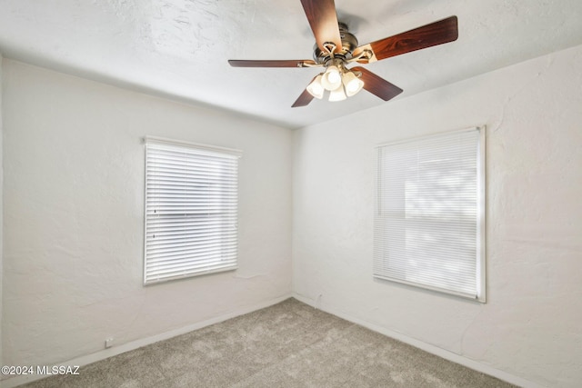 unfurnished room featuring ceiling fan and light colored carpet