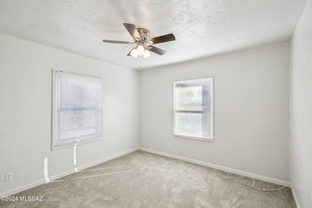 spare room with carpet flooring and ceiling fan