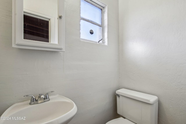 bathroom featuring toilet and sink