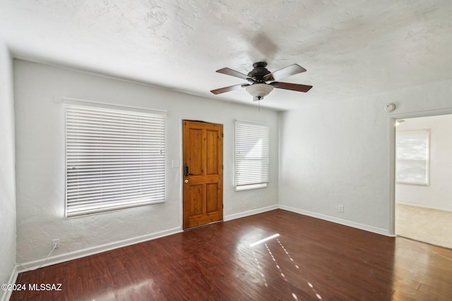 interior space with dark hardwood / wood-style flooring and ceiling fan