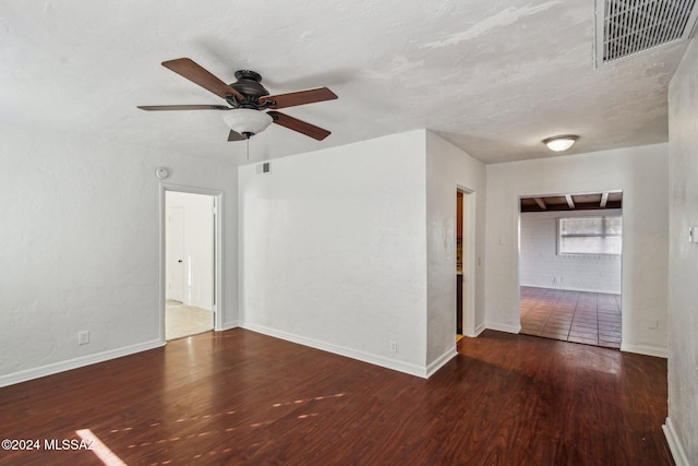 spare room featuring ceiling fan and dark hardwood / wood-style floors