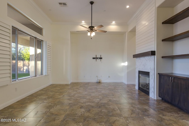 unfurnished living room with crown molding, a fireplace, and ceiling fan