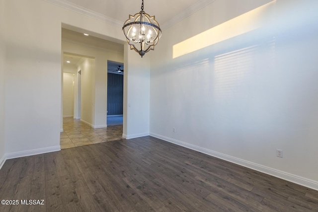 empty room featuring ceiling fan with notable chandelier, dark hardwood / wood-style floors, and ornamental molding