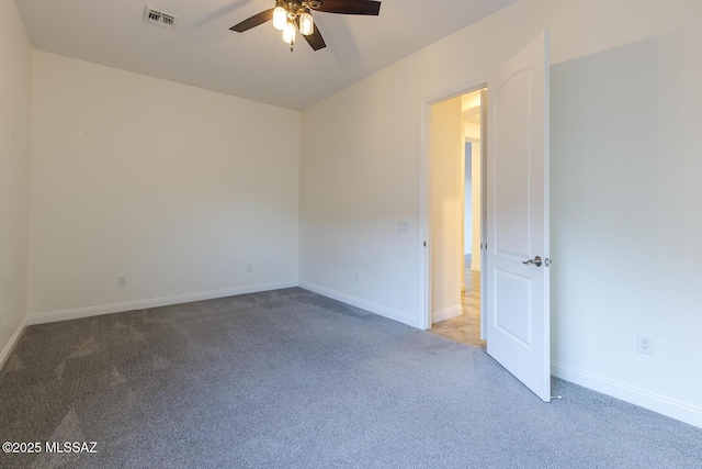 spare room featuring ceiling fan and carpet floors