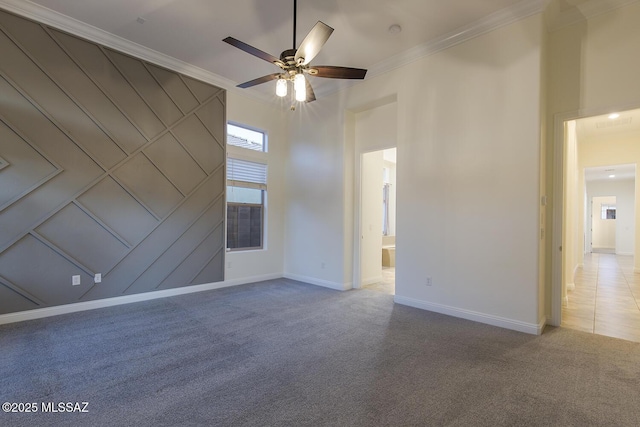 carpeted spare room featuring ceiling fan and ornamental molding