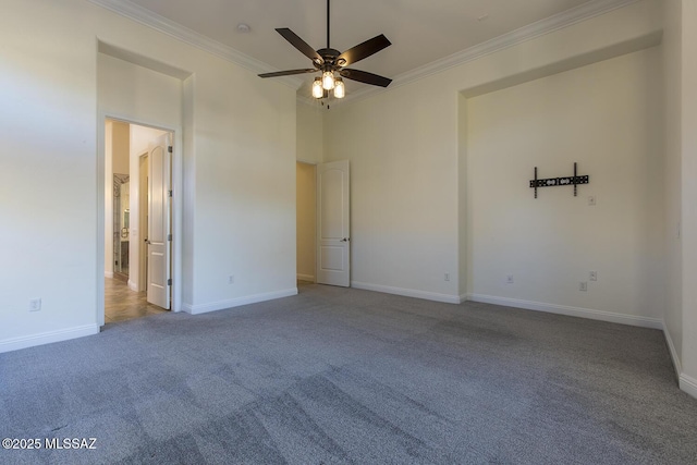 carpeted spare room with crown molding, a towering ceiling, and ceiling fan