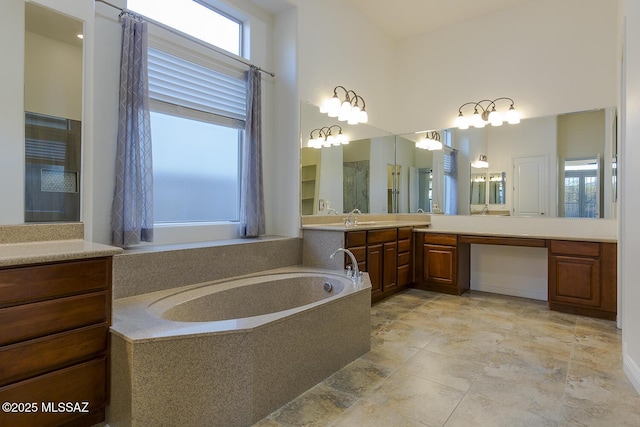 bathroom with a washtub and vanity