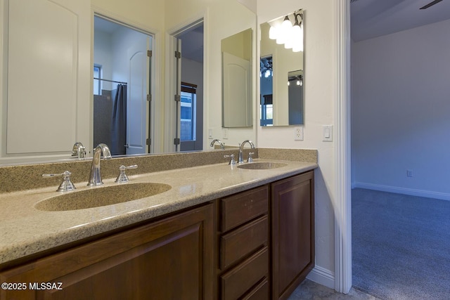 bathroom with ceiling fan and vanity