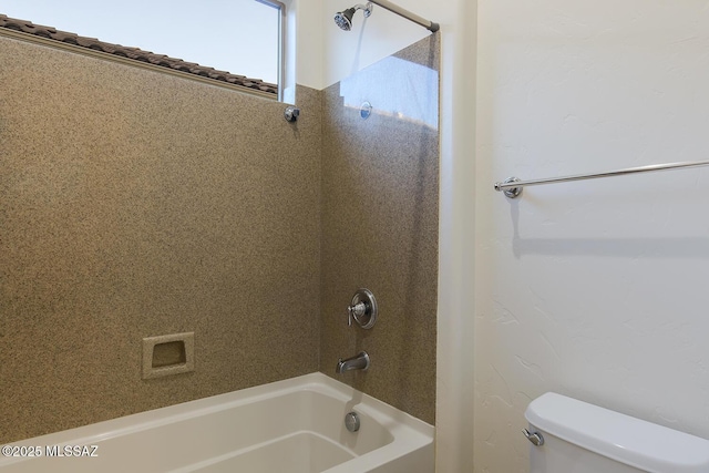 bathroom with bathing tub / shower combination and toilet