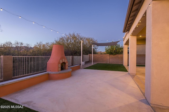 view of patio with exterior fireplace