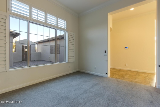 spare room featuring crown molding and light colored carpet