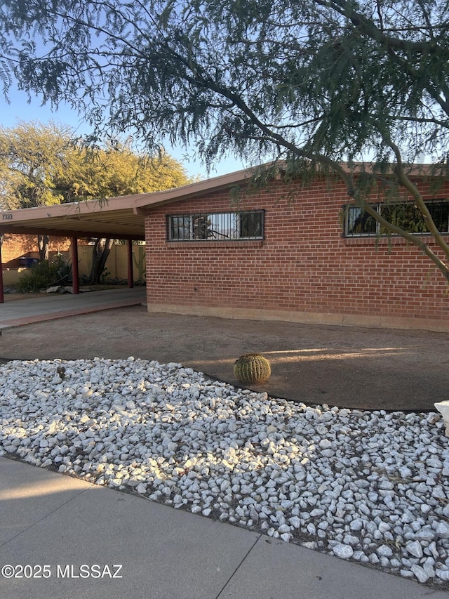 view of side of property with a carport