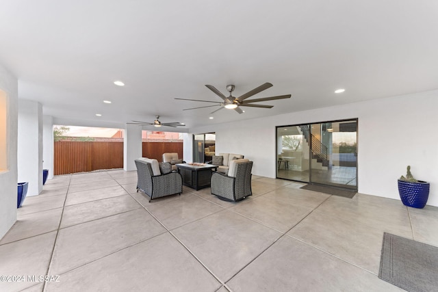 view of patio with an outdoor living space with a fire pit