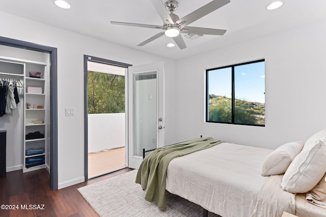 bedroom featuring multiple windows, a closet, ceiling fan, and dark wood-type flooring