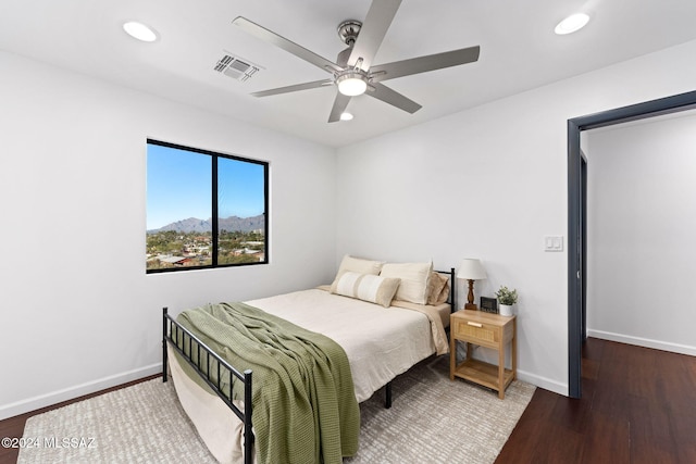 bedroom with ceiling fan and dark wood-type flooring