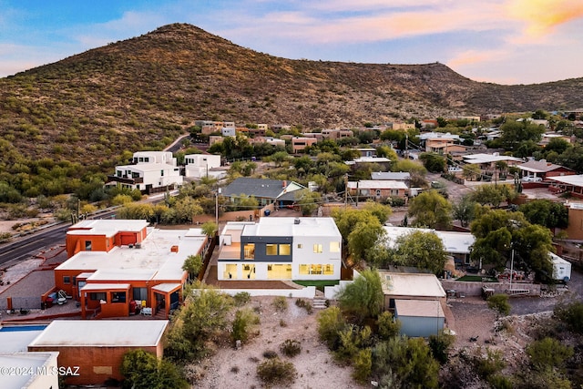 aerial view at dusk featuring a mountain view