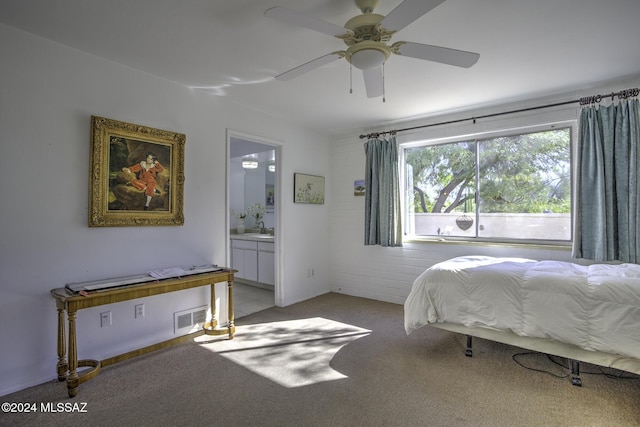 bedroom with light carpet, ensuite bath, ceiling fan, and sink