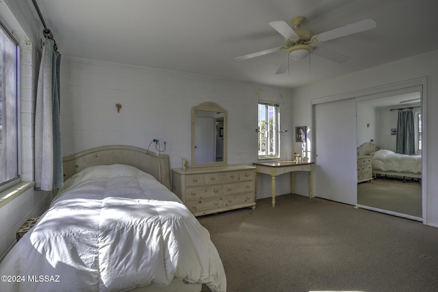 bedroom with carpet, a closet, and ceiling fan