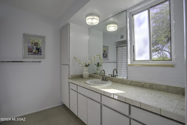 bathroom with tile patterned floors and vanity