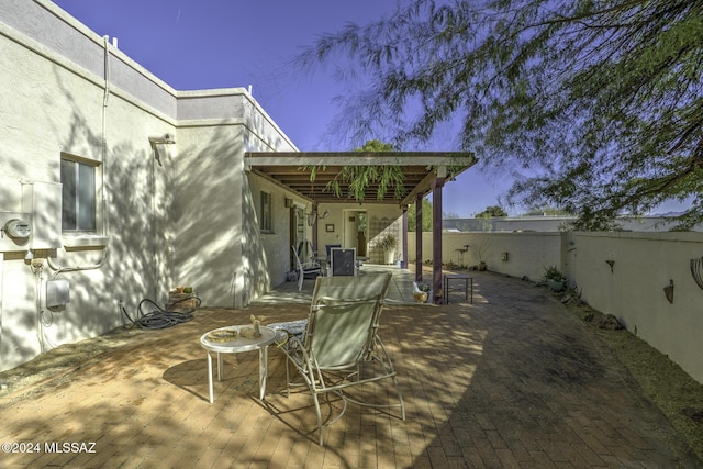 view of patio terrace at dusk