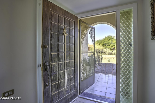 doorway to outside with light tile patterned floors